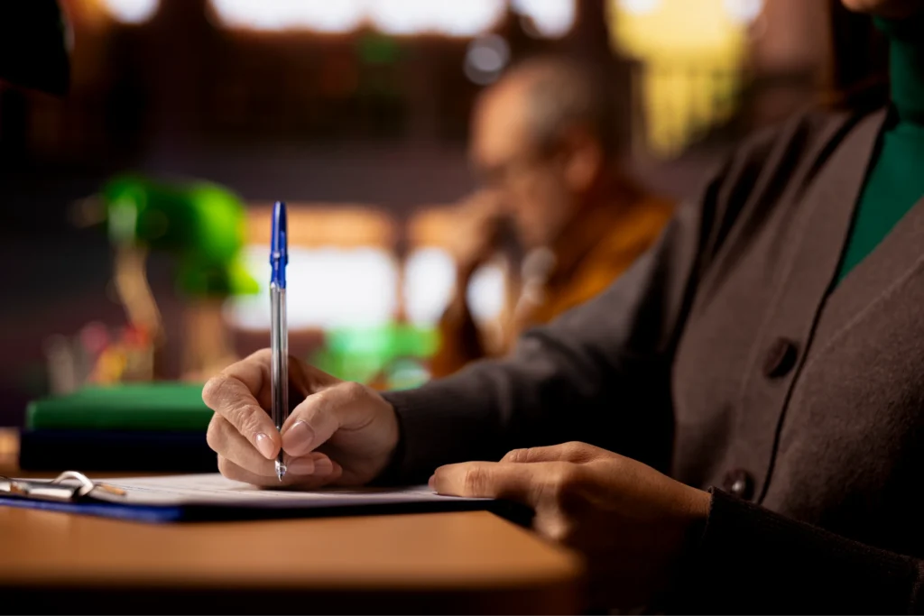 mature person college campus study area writing notes ideas